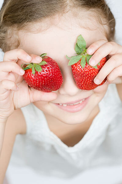 Girl holding strawberries