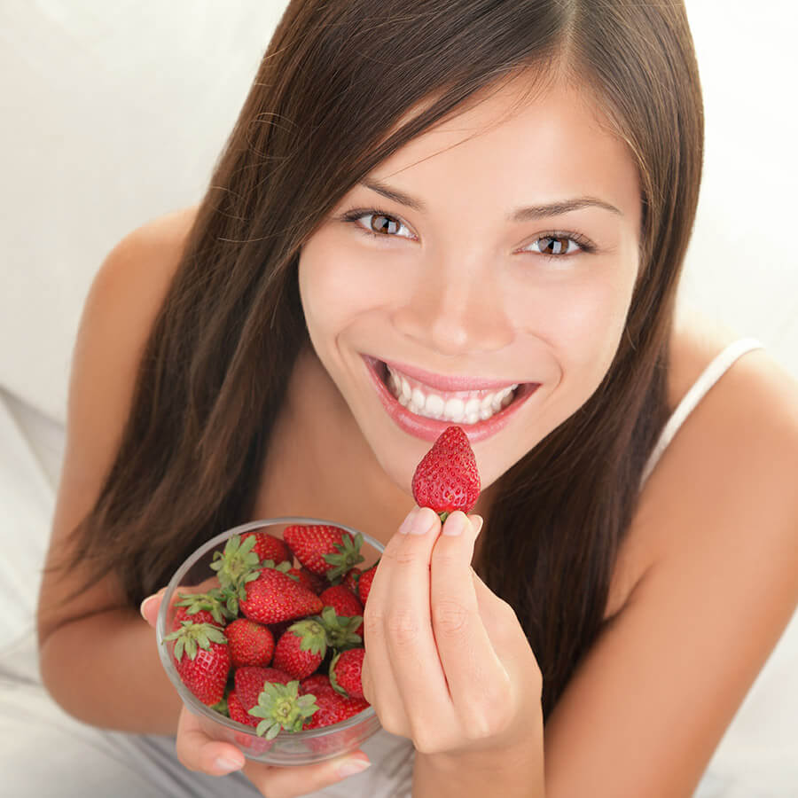 woman eating strawberries